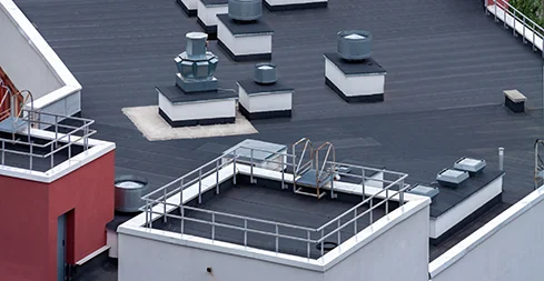 Flat commercial roof with rooftop equipment and membrane seams